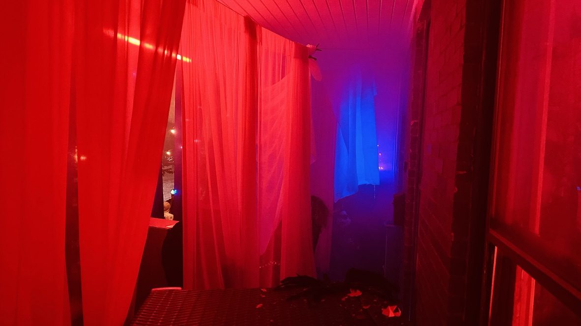 Red curtains, blue glow at the end