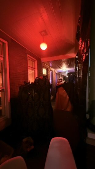 Red-lit tunnel, black draping