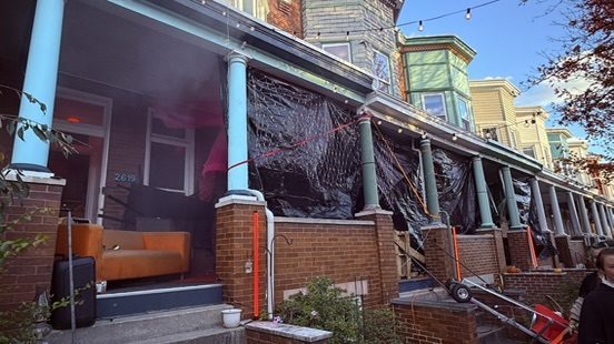 Black tarps on the porch fronts